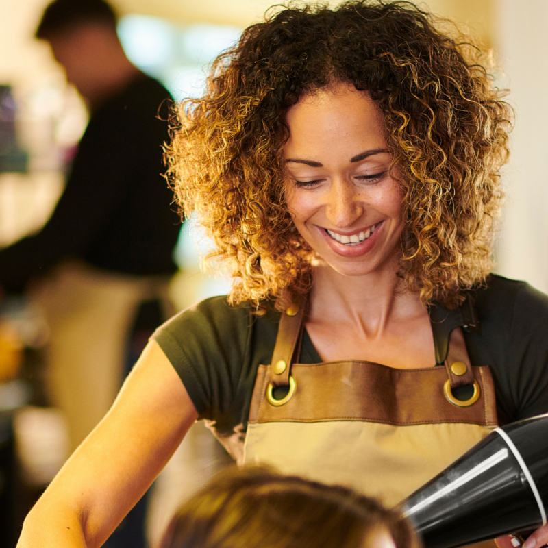 salon stylist blow drying hair