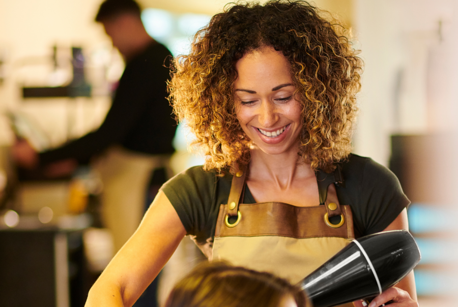 salon stylist blow drying hair